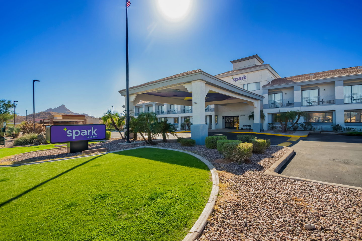 Exterior of a Spark by Hilton hotel with its purple Spark sign